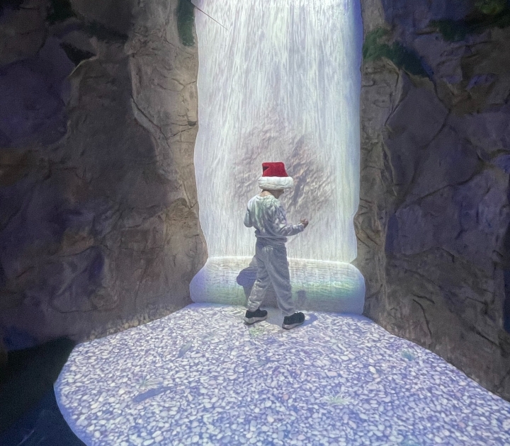 Child using interactive waterfall 