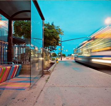 Bus stop with bus moving by