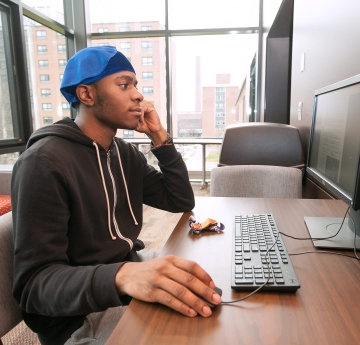 Student working on a computer in Bishop Hall